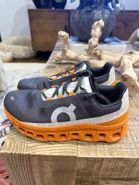 On CloudMonster Black and Orange Sneakers
